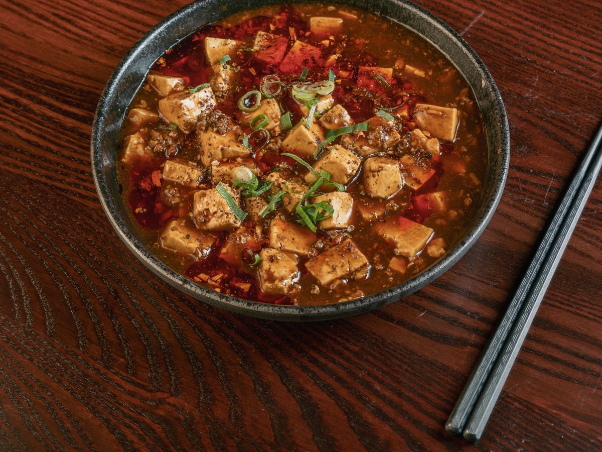 Wagyu mapo tofu in a deep red chilli sauce, topped with spring onion.