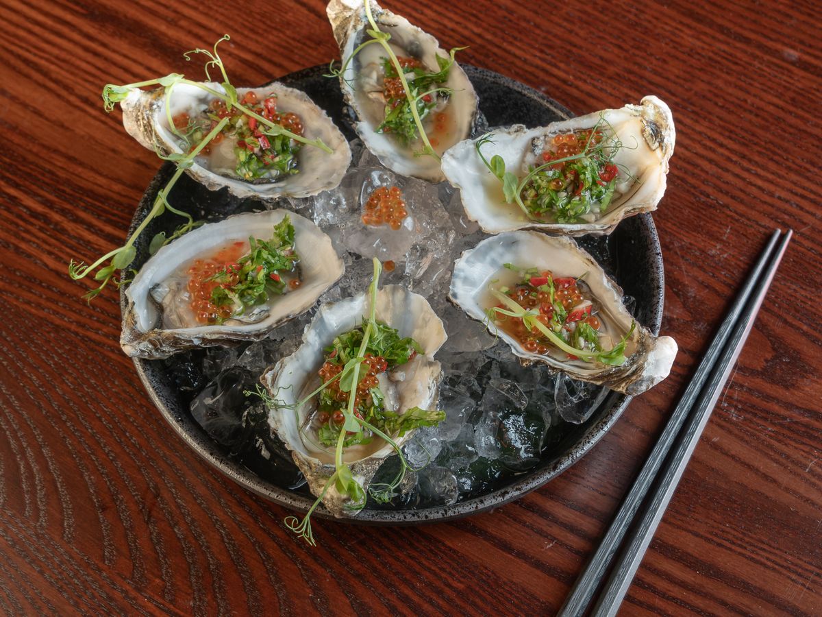 Six oysters on crushed ice, each topped with kimchi, spring onion and chilli.